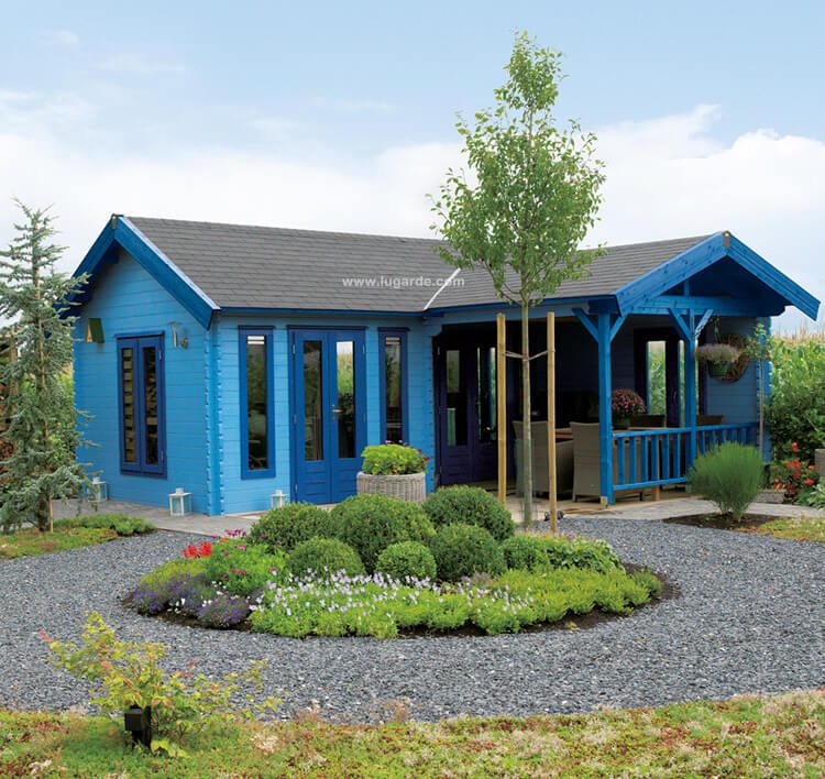 Lugarde Log Cabin B45 is a big log cabin with a saddle roof. Its two rooms provide enough space for everything you might use them for. The integrated patio has two fully open walls one of which is enriched by a wooden balustrate, here painted in dark blue.